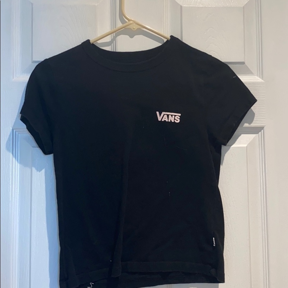 black tee with pink checkers inside the word vans